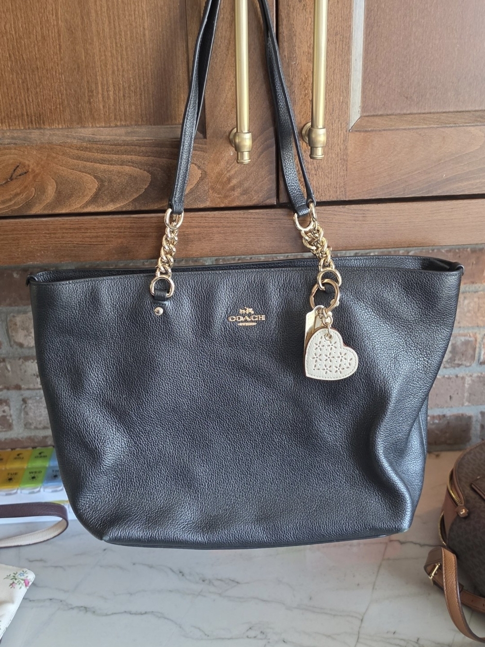 Coach Black Leather Tote with Gold Chain Accents and Heart Charm